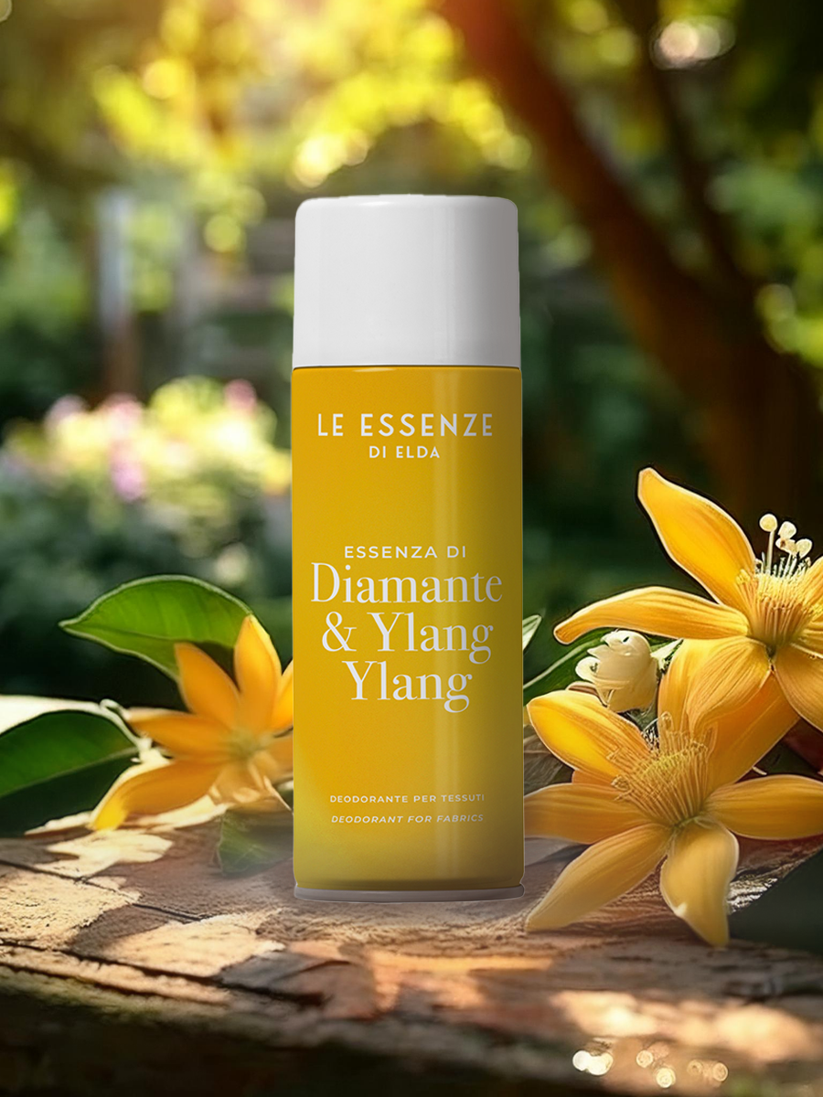 bottle labeled 'Diamante & Ylang Ylang' by 'Le Essenze di Elda' with yellow flowers on a natural background.