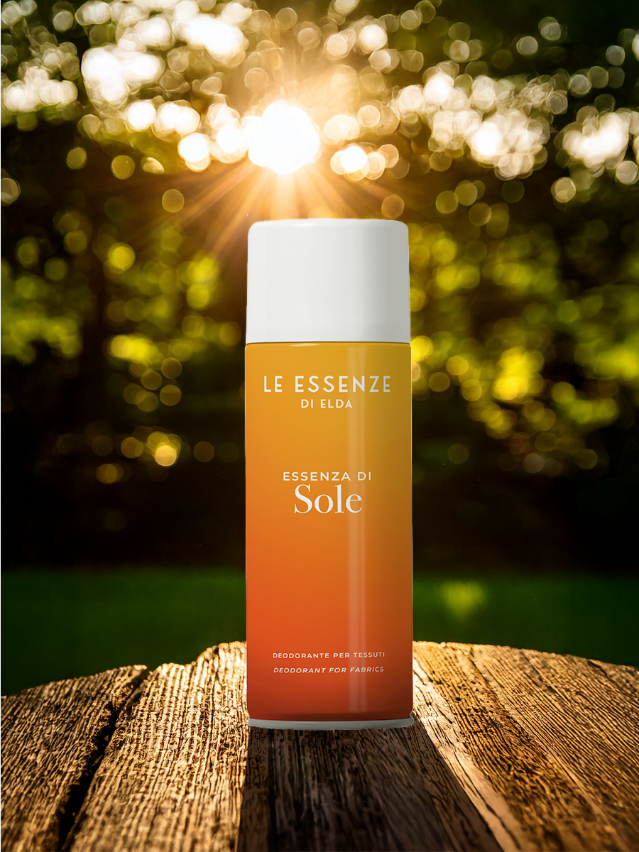 Deodorant bottle labeled 'Le Essenze di Elda' on a wooden surface with a blurred natural background