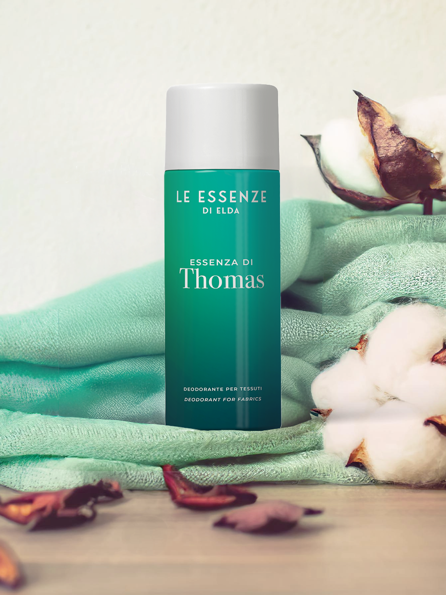 Deodorant bottle labeled 'Le Essenze di Elda' with cotton and green fabric in the background